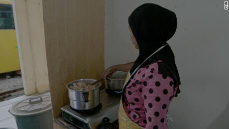 Masita, a former pepper farmer, now sells meals from a small stall after her land was seized by a nickel mining company.